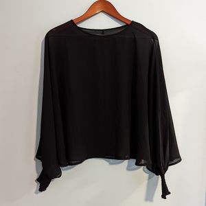 Sheer black poncho with ruched cuffs